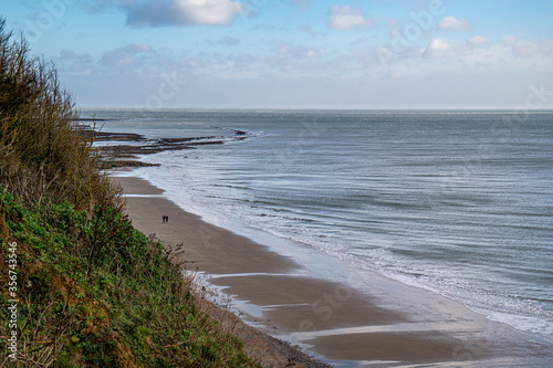 Two walkers on the beach on an early morning stroll