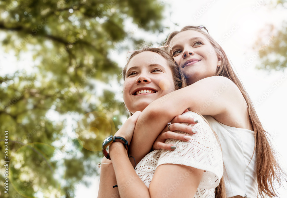Two best friends hugging outside in a summer day having fun Two best friends hugging outside in a summer day having fun