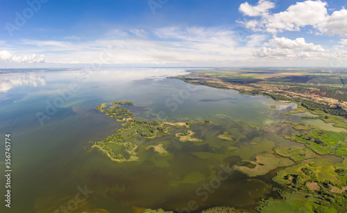aerial view of islands with lush greenery in a freshwater river in summer. European landscape.