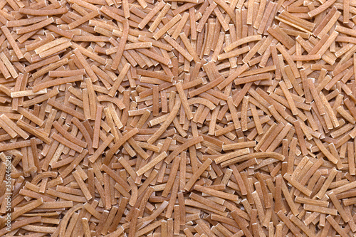 Scattered brown flat vermicelli texture. Pastry pattern, food background, texture idea