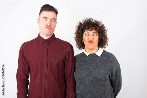 Photography Funny comic girl crosses eyes, puts lips, makes grimace, foolishes after all day studying