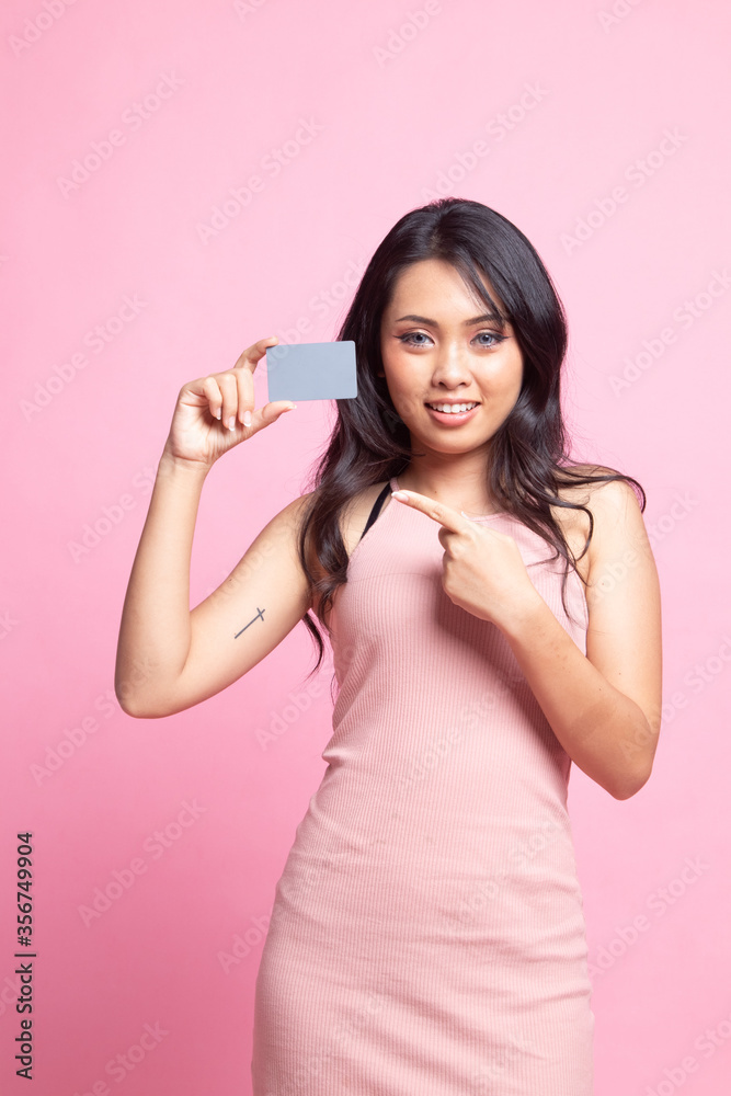 Young Asian woman point to a blank card. Young Asian woman point to a blank card.