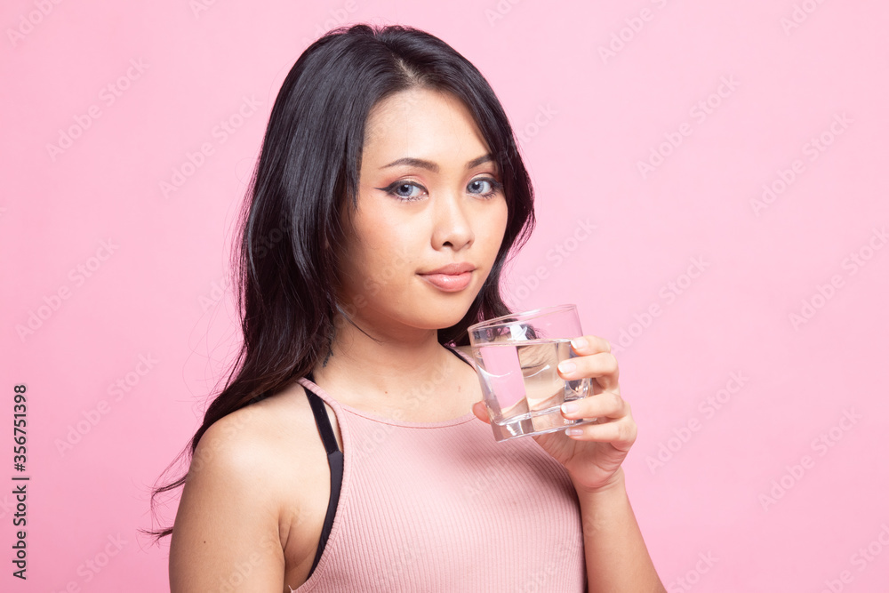 Young Asian woman with a glass of drinking water. Young Asian woman with a glass of drinking water.
