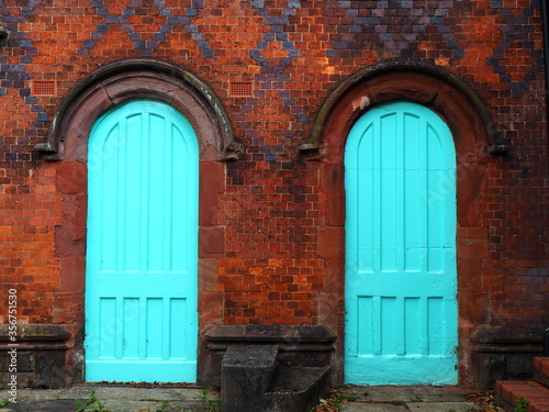 Two turquoise doors in old building
