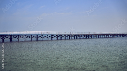 bridge on the shore of the beautiful sea goes to the horizon