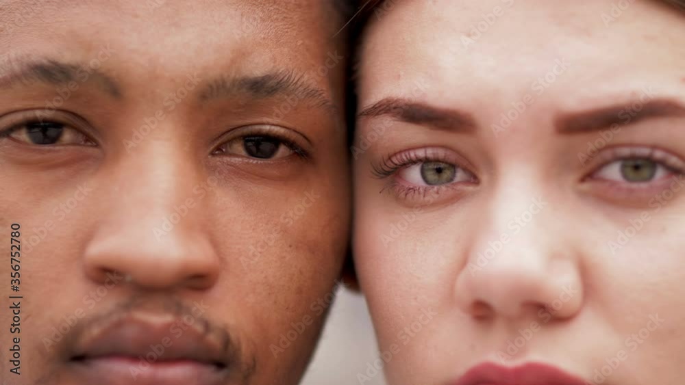 Close up portrait of black guy and white girl. Concept of relationships and unity between different human races.