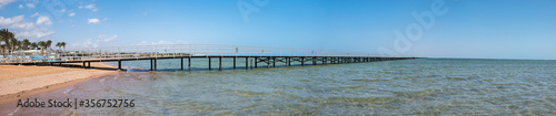 bridge on the shore of the beautiful sea goes to the horizon