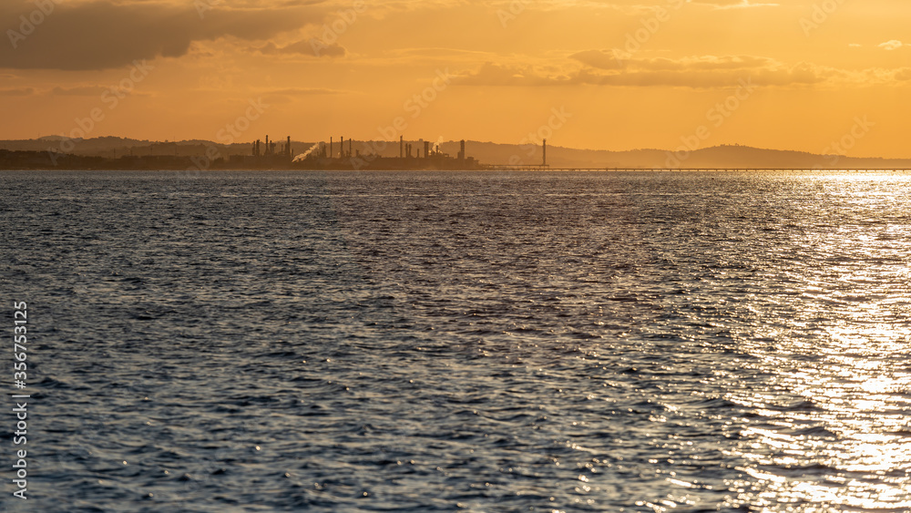 Raffineria di petrolio di Falconara vista dal mare al tramonto