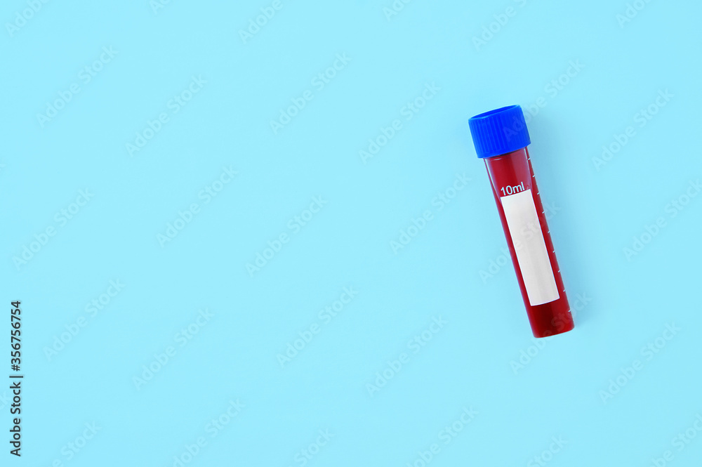 Blood in plastic test tube on blue background. View from above. Blood in plastic test tube on blue background. View from above.
