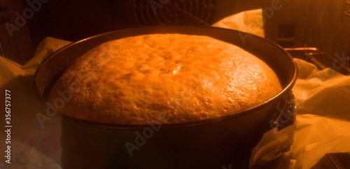 Homemade sponge cake being made inside the oven with heat blur photo