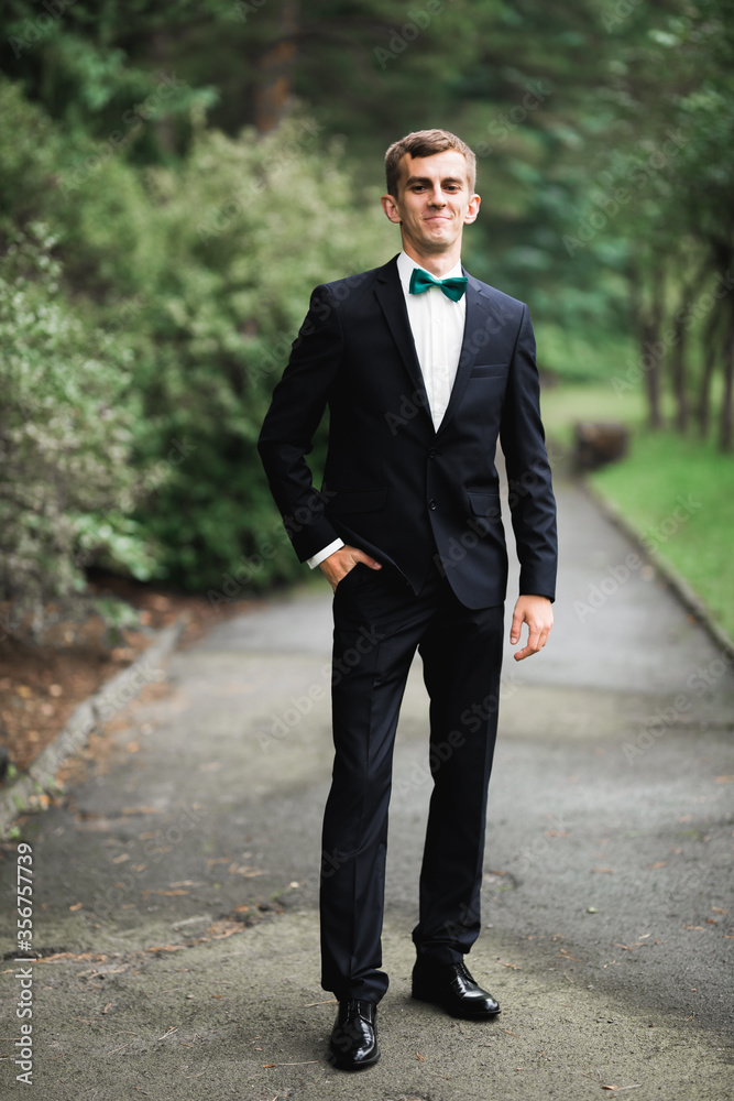 Headshot portrait of young man smiling isolated on outside outdoors background Headshot portrait of young man smiling isolated on outside outdoors background