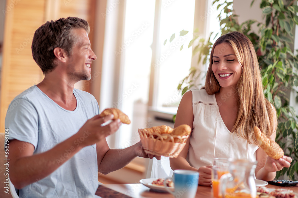 Couple have breakfast at home.