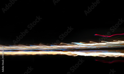 the sparkling strip rushes forward like a multicolored fire over the water - a swift background isolated on black