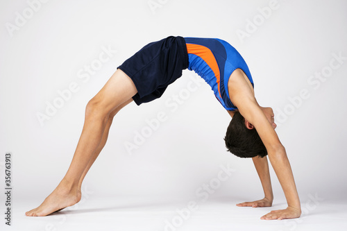 Male child gymnast doing floor routine poses