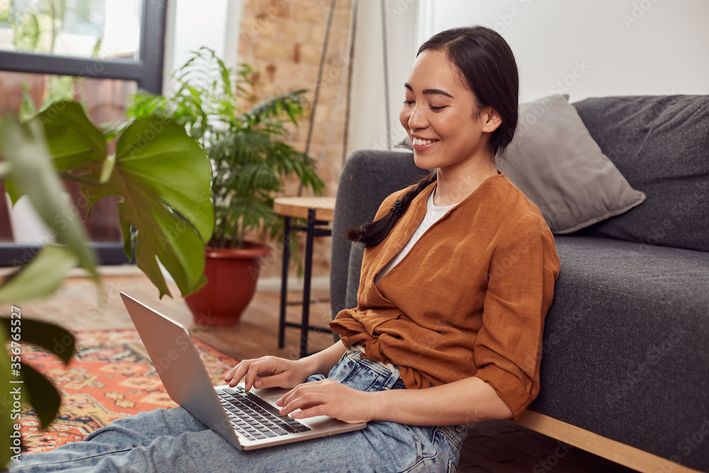 Lovely young woman working with laptop at home Lovely young woman working with laptop at home