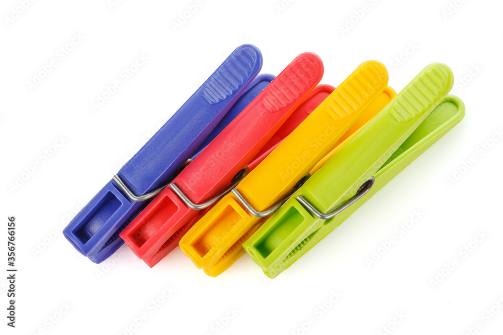Color plastic clothespins isolated on white background. Plastic clips. Close-up. Color plastic clothespins isolated on white background. Plastic clips. Close-up.