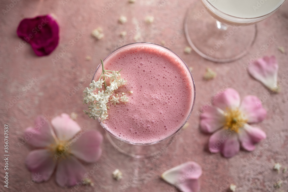 A glass of kefir with blended raspberries and elder flowers A glass of kefir with blended raspberries and elder flowers