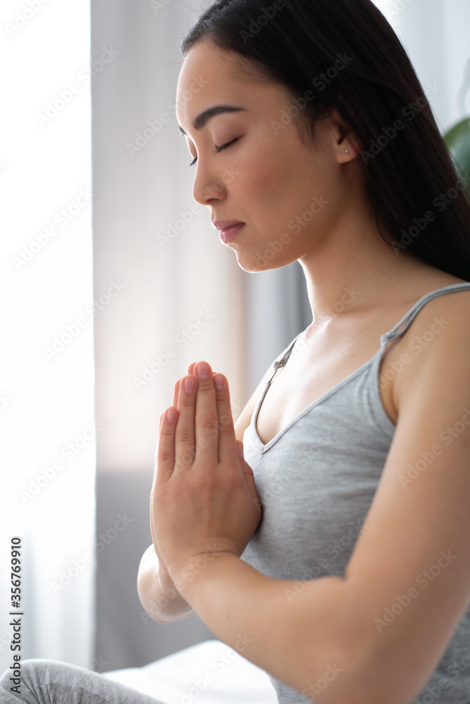 Young pretty woman doing meditation with closed eyes Young pretty woman doing meditation with closed eyes