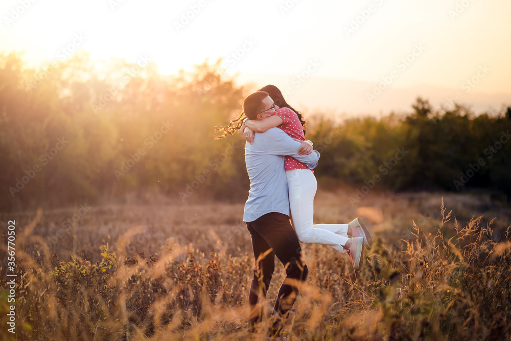Outdoor portrait of young couple, boyfriend lifts his girlfriend in air. Outdoor portrait of young couple, boyfriend lifts his girlfriend in air.