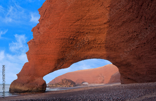 Famous Legzira Beach on Atlantic coast in Morocco, North Africa. One of two rock archways at Legzira beach on Morocco’s Atlantic coast has collapsed in 2016.