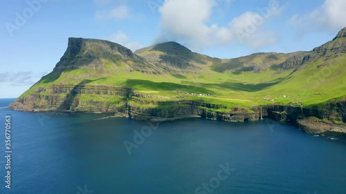 4k drone forward video (Ultra High Definition)  of Mulafossur Waterfall. Superb summer view of Vagar island, Faroe Islands,  Denmark, Europe. Beauty of nature concept background.