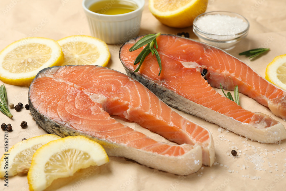 Salmon meat and spices on baking paper background, close up Salmon meat and spices on baking paper background, close up
