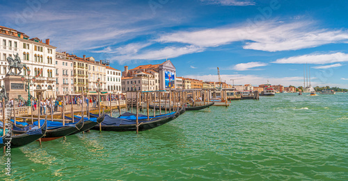 Panoramic view over busy Grand Canal, piers, promenade embankment, colorful buildings and Monument of King Victor Emmanuel II in Venice, Italy