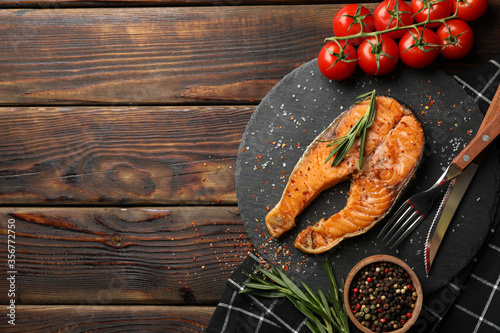 Composition with tasty grilled salmon on wooden background, top view