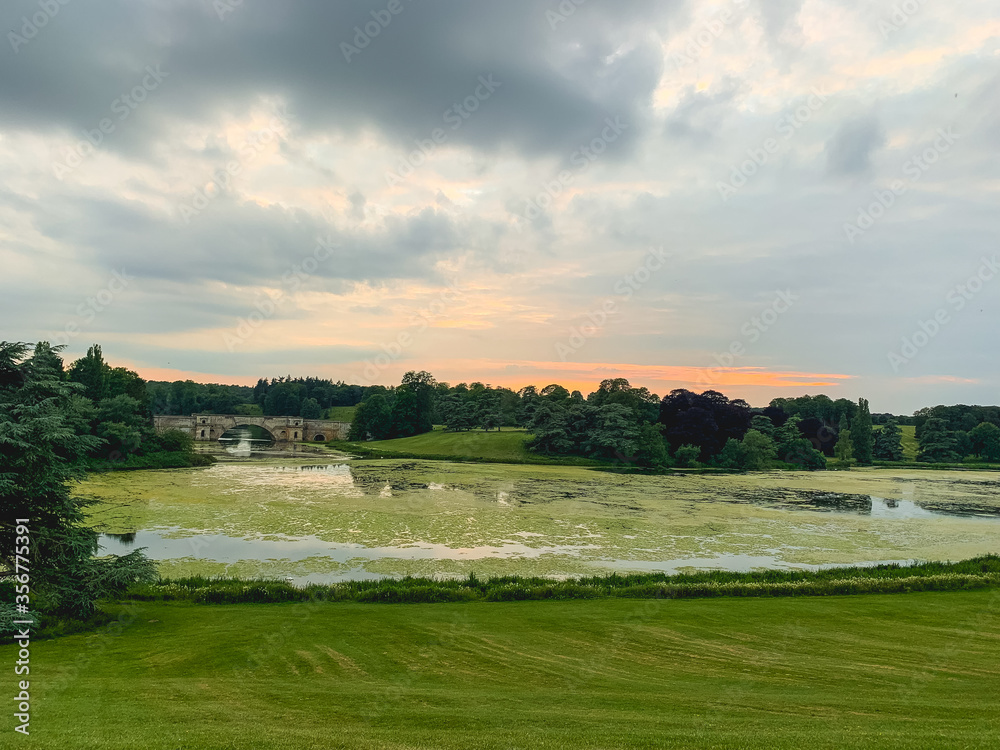 Blenheim Palace in the UK and its lake at sunset Blenheim Palace in the UK and its lake at sunset