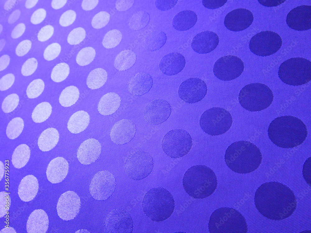 Lilac fabric with jacquard polka dots.