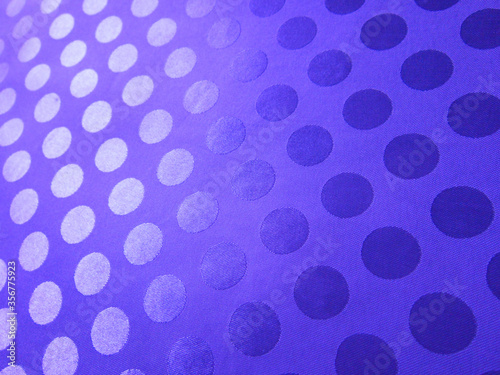 Lilac fabric with jacquard polka dots.