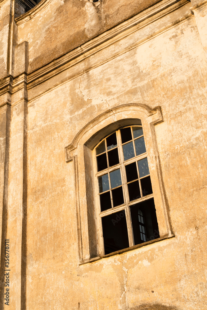 The window of an old church in the rays of the evening sun The window of an old church in the rays of the evening sun
