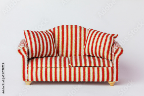 an old sofa with pillows-a miniature from a doll's house. striped upholstery material