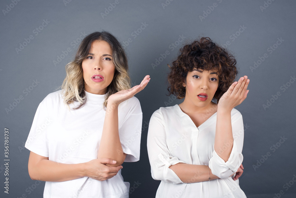 What the hell are you talking about, nonsense. Studio shot of frustrated female with blonde hair gesturing with raised palm, frowning, being displeased and confused with dumb question over gray wall. What the hell are you talking about, nonsense. Studio shot of frustrated female with blonde hair gesturing with raised palm, frowning, being displeased and confused with dumb question over gray wall.