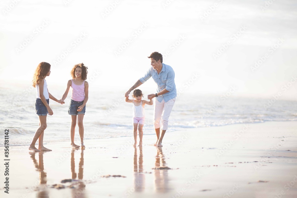 father and daughters at the beach
