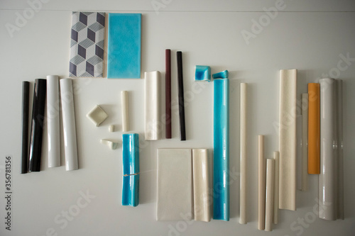 Zagreb Croatia-June 4th 2020  Set of tiles in various colors  shapes and materials  placed on white table for clients to choose desired combination in interior design planning