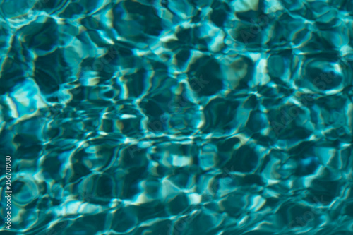 Clear and transparent blurred Swimming Pool Water background.