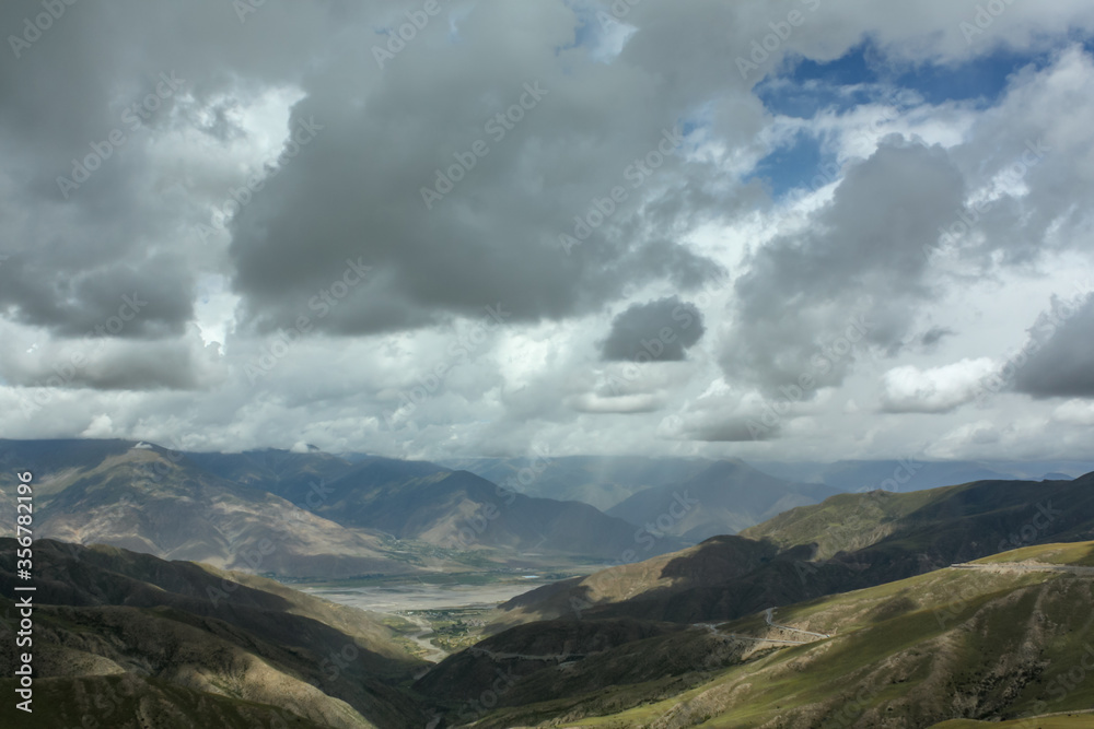 Highpass in Tibet not far away from Lhasa with clouds hanging very low Highpass in Tibet not far away from Lhasa with clouds hanging very low