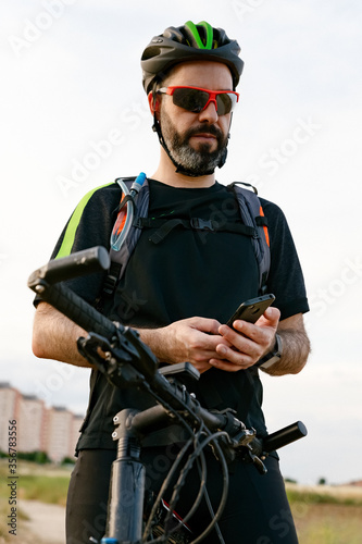Cyclist watching the gps from his mobile