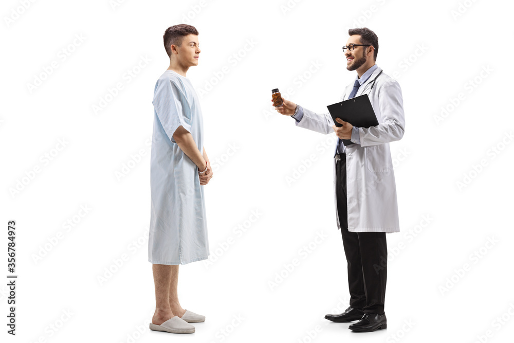 Doctor giving a bottle of pills to a hospitalized male patient