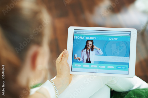 stylish woman with opened digital dental site