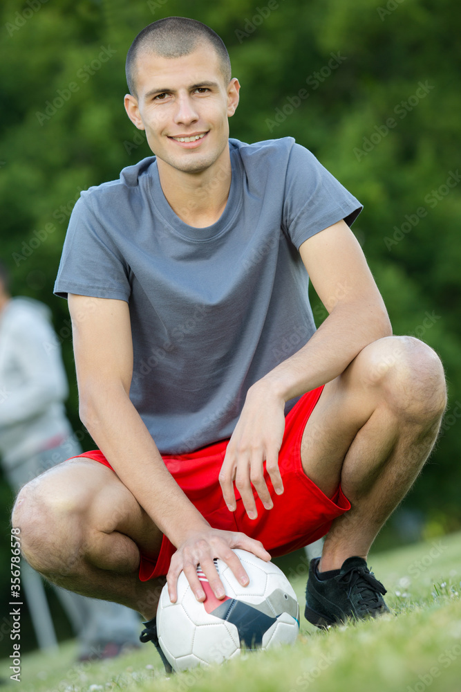 a male footballer playing football a male footballer playing football