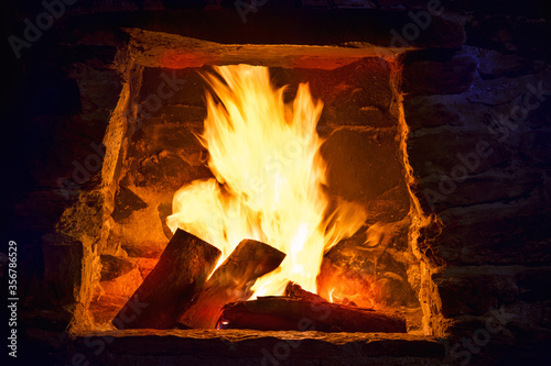 Fire place with burning logs.