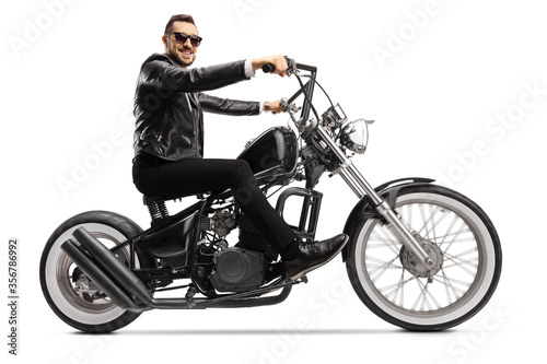 Handsome man biker on a custom chopper