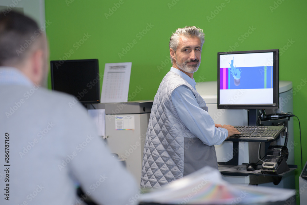 worker or production manager working on a computer