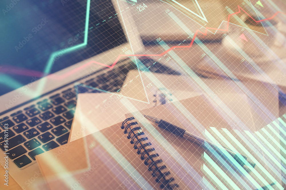 Double exposure of financial chart drawing and desktop with coffee and items on table background. Concept of forex market trading Double exposure of financial chart drawing and desktop with coffee and items on table background. Concept of forex market trading