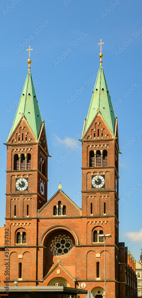 Tower clocks with Roman numbers at bell towers of Catholic Cathedral in Maribor, Slovenia.