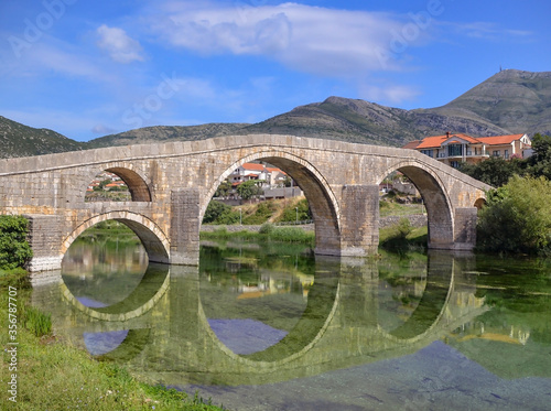 Old stone made Perovica Arslanaginica Bridge over river Trebisnjice in Trebinje  Bosnia and Herzegovina.