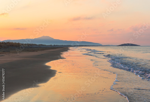 Fantastic Mediterranean seascape in Turkey. Amazing sunrise on Patara beach  Mugla Province.  Morning orange clouds reflected in calm water.
