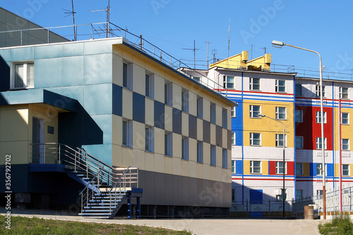 The building of a sports school and colorful houses in the city of Anadyr. Chukotka, Far East of Russia.